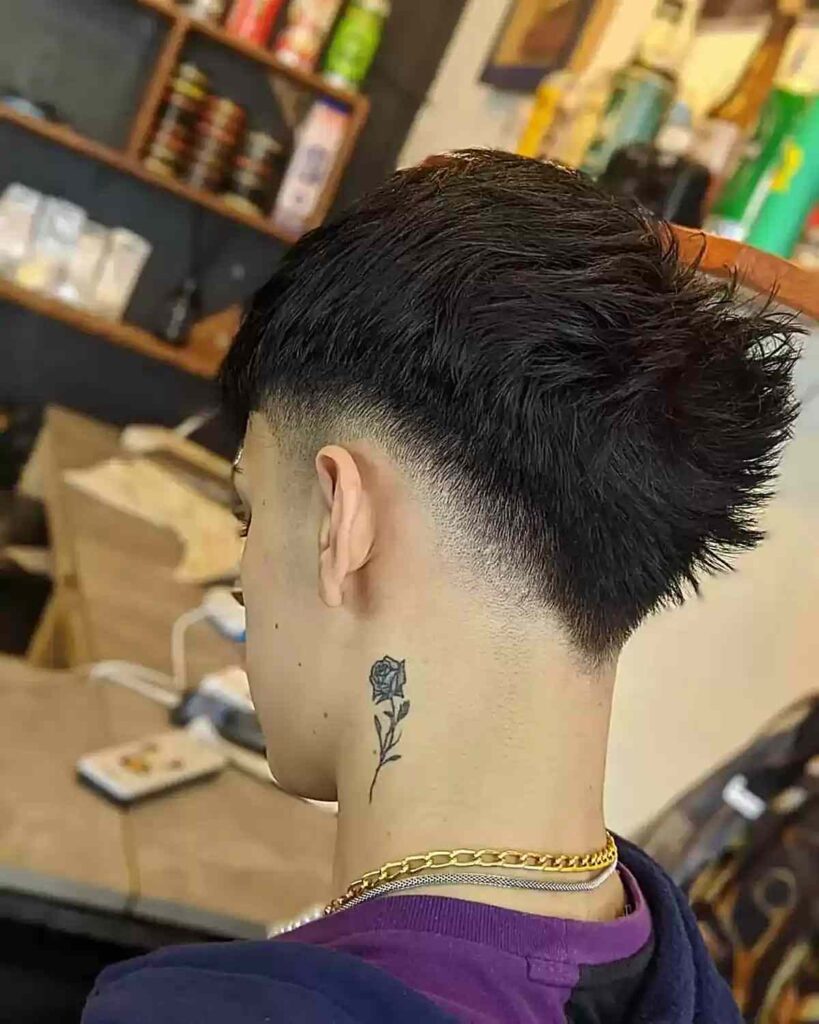 low fade v shaped cut with spiky top on mens thicker hair