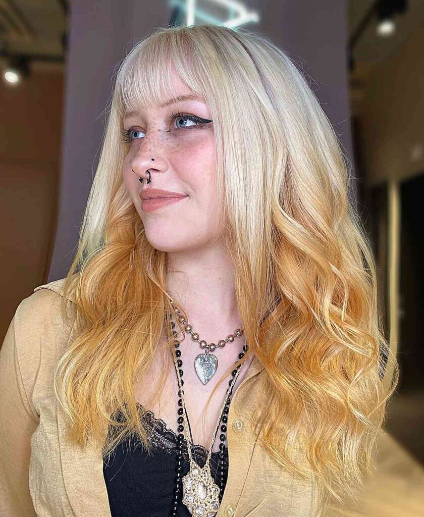 90s inspired reverse bleach blonde ombre with bangs