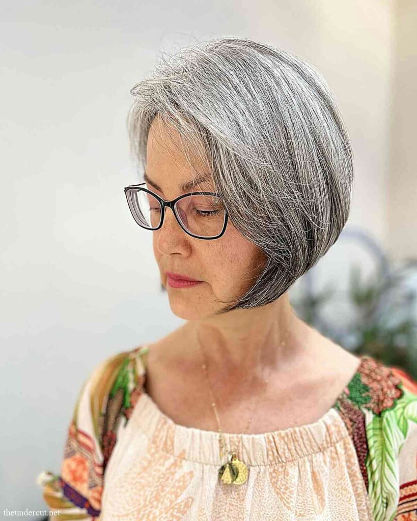 chin length grey bob with side part for women aged 60 with thick tresses