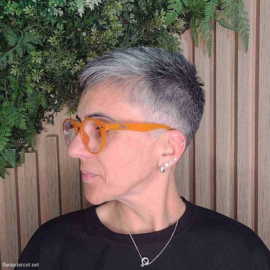 cropped pixie haircut with silver strands for 50 year old women with specs