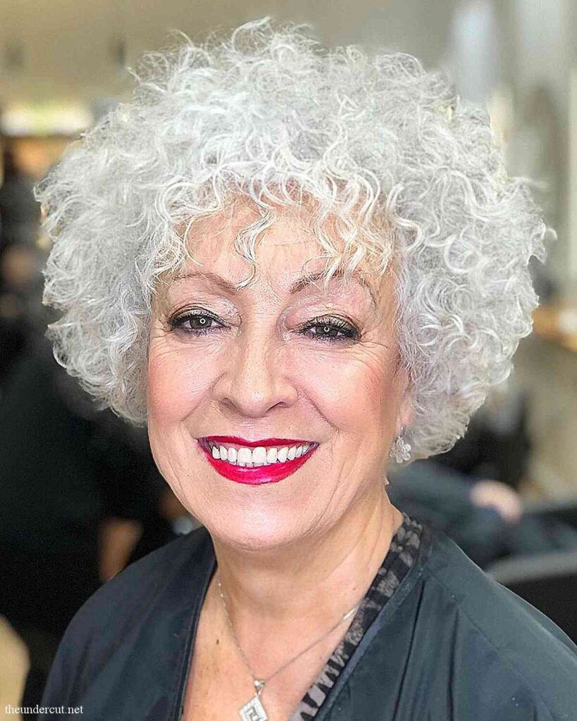 curly round bob with piecey bangs for thick haired women over sixty