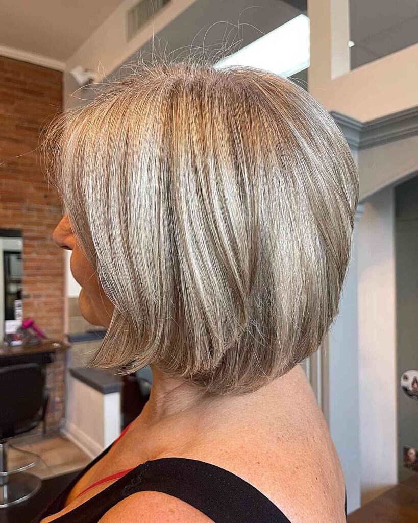 layered bob with beige silver highlights for mature women with grey hair