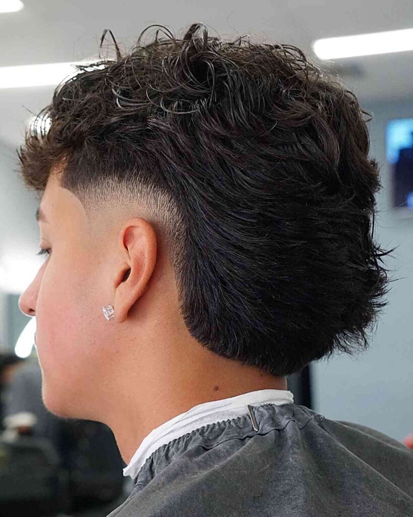 medium length textured mullet with low burst fade for young men