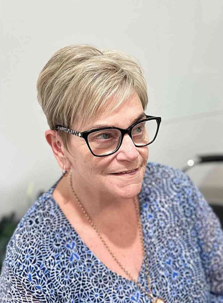 very short pixie hair with side swept bangs for women aged 50 with glasses