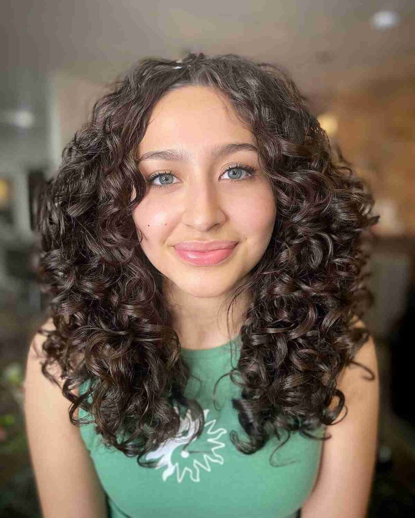center parted medium hair with layered curls for round faces