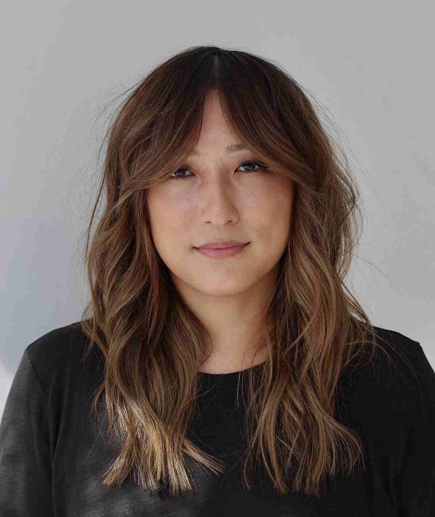 medium length layered waves with curtain bangs for round faces