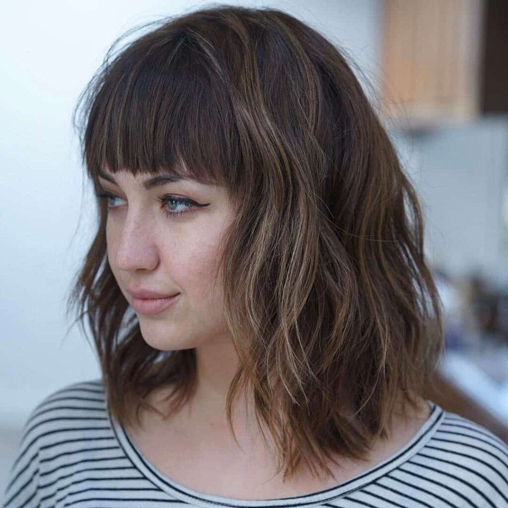 textured lob with bangs and round face shape